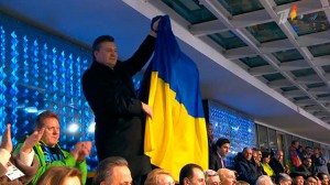 President of Ukraine Victor Yanukovych waving national flag as the Ukrainian team advanced to the stadium during Opening ceremony, Sochi, February 7, 2014.