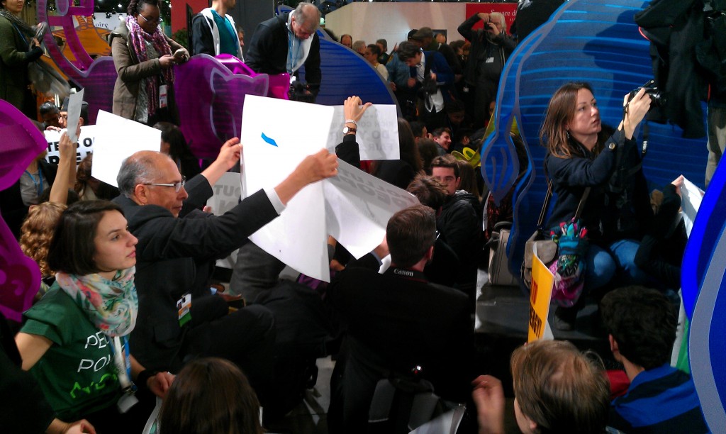 Activists at an unauthorized protest on December 9 inside the climate negotiations in Paris. Photo: Peter Teffer.
