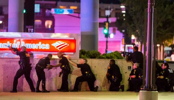 Dallas police respond to an organized sniper assault on cops at a protest against police abuse